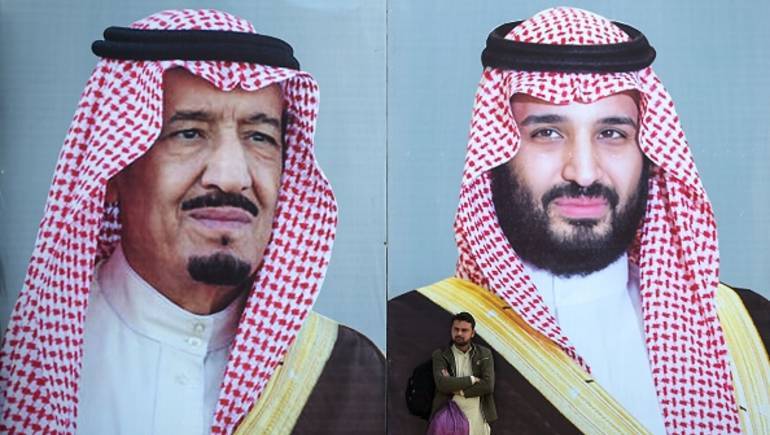 A Pakistani man waits for transport in front of billboards showing portraits of Saudi Arabian Crown Prince Mohammed bin Salman (R) and his father and Saudi Arabia's King Salman bin Abdulaziz displayed on a street ahead of the prince's arrival in Islamabad on February 15, 2019. - Pakistan is preparing to welcome Saudi Arabian Crown Prince Mohammed bin Salman for a state visit over February 16 and 17, the foreign ministry confirmed as Islamabad hopes to sign various investment deals to prop up its slumping economy. (Photo by AAMIR QURESHI / AFP)        (Photo credit should read AAMIR QURESHI/AFP/Getty Images)