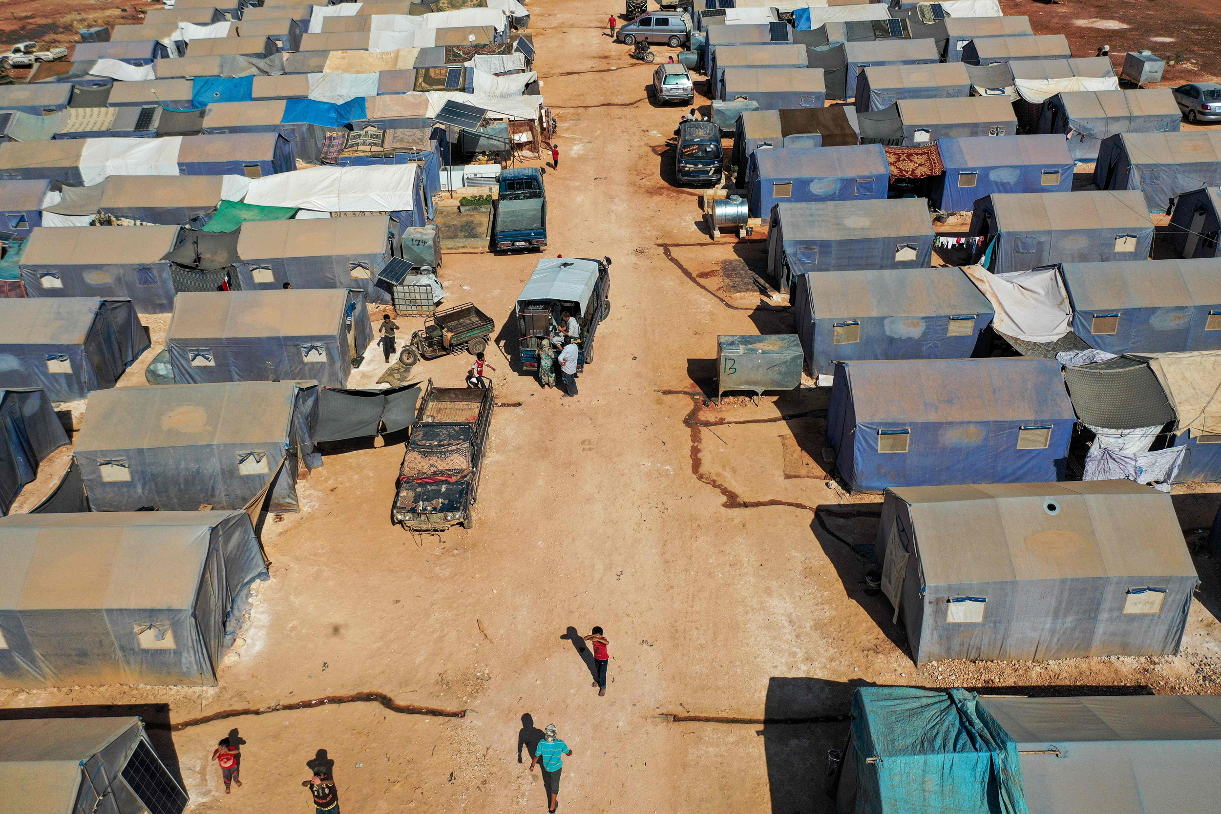 This picture taken on July 9, 2020 shows an aerial view of tents at the Azraq camp for displaced Syrians near the town of Maaret Misrin in Syria's northwestern Idlib province, sheltering several hundred families displaced by conflict from the northern Hama and southern and eastern Idlib countrysides. - Displaced Syrians relying on humanitarian assistance voiced alarm after regime ally Russia tried to reduce cross-border aid to millions in the northwest of the war-torn country. The Russian motion at the UN Security Council was voted down, but a council resolution authorising aid deliveries through the Turkish border expires on July 10. An estimated 2.8 million people depend on aid in northwest Syria, including in the country's last major opposition bastion of Idlib, the United Nations says. (Photo by Omar HAJ KADOUR / AFP) (Photo by OMAR HAJ KADOUR/AFP via Getty Images)