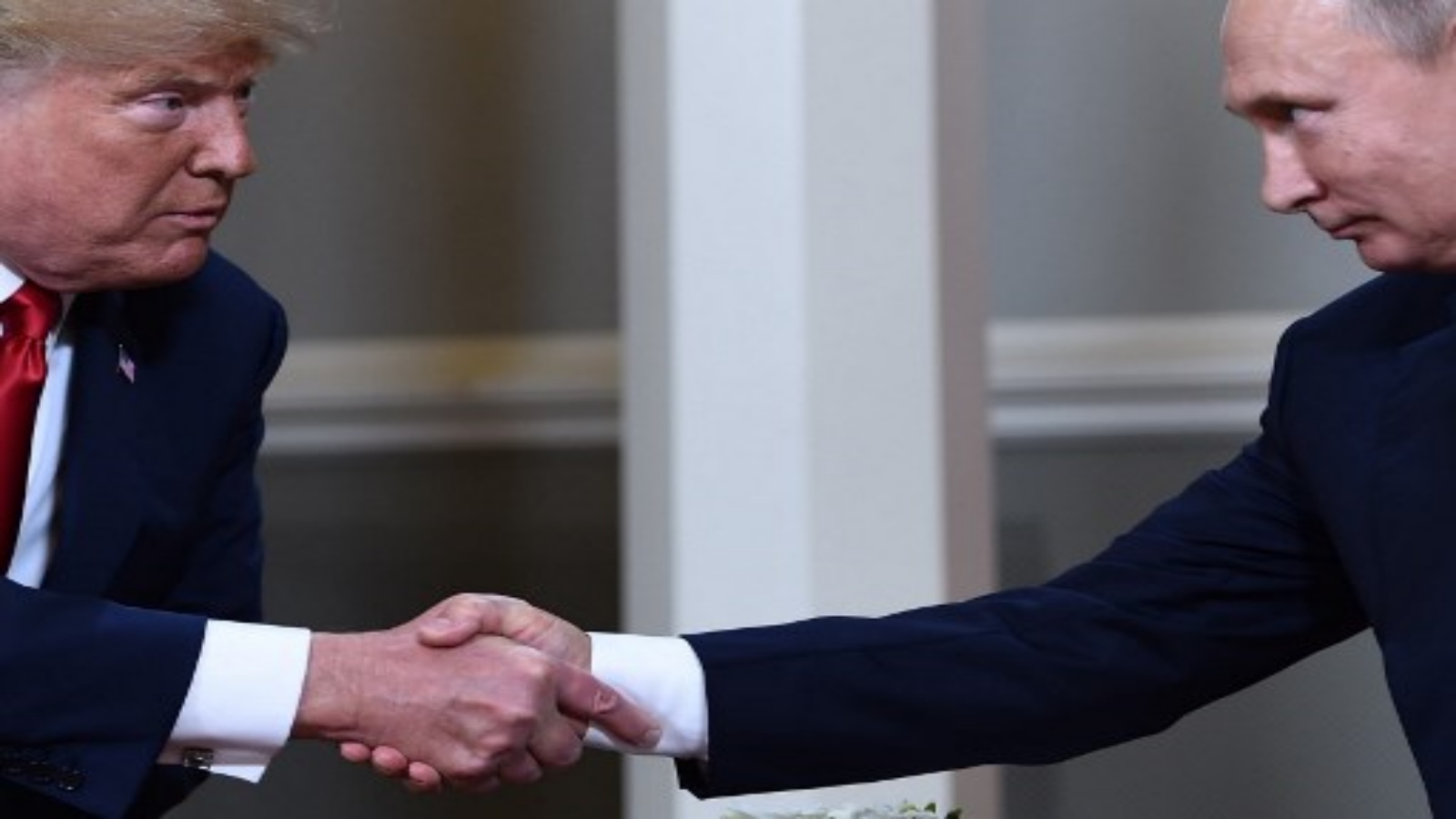 (FILES) In this file photo taken on July 16, 2018 US President Donald Trump (L) and Russian President Vladimir Putin shake hands ahead a meeting in Helsinki. - US President Donald Trump, who is seeking reelection on November 3, has regularly jolted the world with statements about other leaders that sharply deviate from long-held diplomatic protocol. (Photo by Brendan Smialowski / AFP)