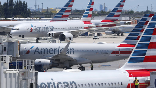 FILE - In this April 24, 2019, photo, American Airlines aircraft are shown parked at their gates at Miami International Airport in Miami. A veteran airline mechanic has been sentenced to three years in prison for sabotaging an American Airlines jetliner in Miami with 150 people aboard. The lawyer for 60-year-old Abdul-Majeed Marouf Ahmed Alani said at a hearing Wednesday, March 4, 2020, that the mechanic's sole motive in July was to earn overtime fixing the plane. (AP Photo/Wilfredo Lee, File)