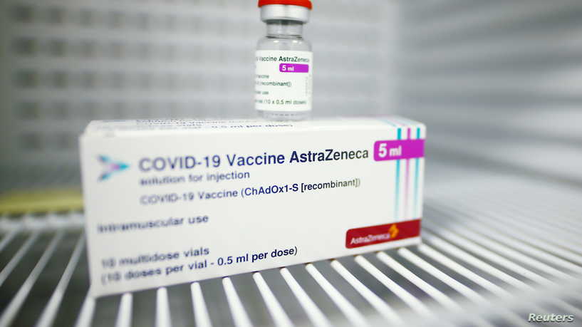 Packages and a vial of AstraZeneca's COVID-19 vaccine are presented for a pictures at a vaccination centre, temporarily set up in a hall of the fair, amid the coronavirus disease pandemic in Cologne, Germany, March 18, 2021. REUTERS/Thilo Schmuelgen