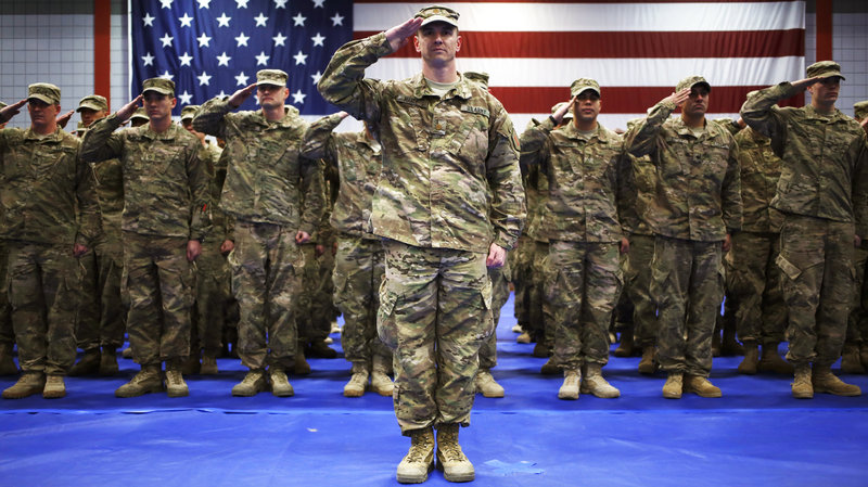 As the U.S. winds down the Afghan war, the government is eyeing a much reduced military force — to its lowest level since World War II. Here, soldiers from the U.S. Army's 3rd Brigade Combat Team, 1st Infantry Division, salute during the playing of "The Star-Spangled Banner" during a homecoming ceremony Feb. 27 in Fort Knox, K