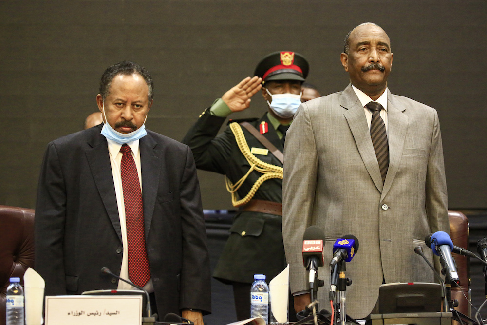 (L to R) Sudan's Prime Minister Abdalla Hamdok and Sovereign Council chief General Abdel Fattah al-Burhan attend the opening session of the First National Economic Conference in the capital Khartoum on September 26, 2020. (Photo by ASHRAF SHAZLY / AFP)