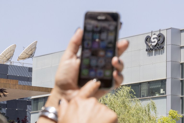 An Israeli woman uses her iPhone in front of the building housing the Israeli NSO group, on August 28, 2016, in Herzliya, near Tel Aviv.
Apple iPhone owners, earlier in the week, were urged to install a quickly released security update after a sophisticated attack on an Emirati dissident exposed vulnerabilities targeted by cyber arms dealers.
Lookout and Citizen Lab worked with Apple on an iOS patch to defend against what was called "Trident" because of its triad of attack methods, the researchers said in a joint blog post.
Trident is used in spyware referred to as Pegasus, which a Citizen Lab investigation showed was made by an Israel-based organization called NSO Group. / AFP PHOTO / JACK GUEZ
