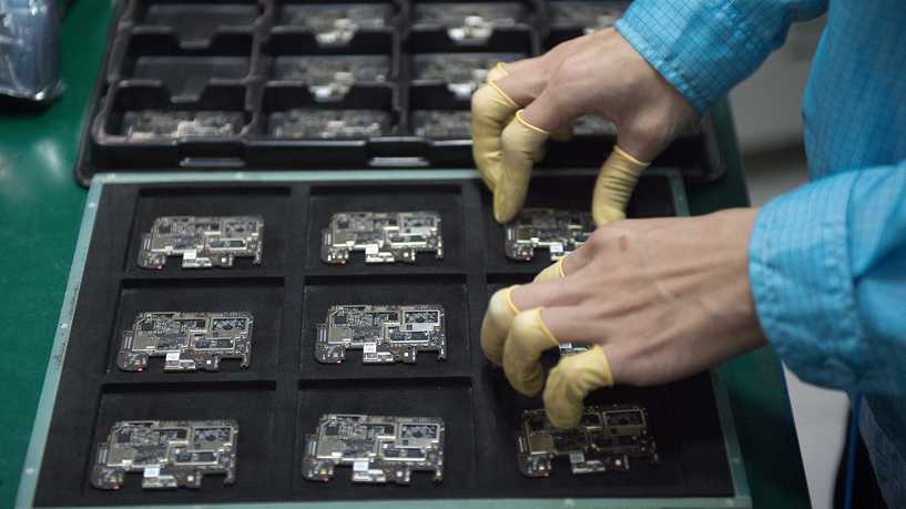 In this picture taken on May 8, 2017, a worker checks chip component circuits at the Oppo factory in Dongguan. - Chinese smartphone maker Oppo began life selling DVD players in the in the southern manufacturing hub of Dongguan a little more than a decade ago and only broke into the handset market in 2011. But with an aggressive marketing strategy and concentration on bricks-and-mortar stores in small and medium-sized cities -- rather than relying on online customers -- sales have soared. (Photo by Nicolas ASFOURI / AFP) / TO GO WITH China-US-SKorea-telecommunication-wireless-Oppo, FOCUS by Julien GIRAULT