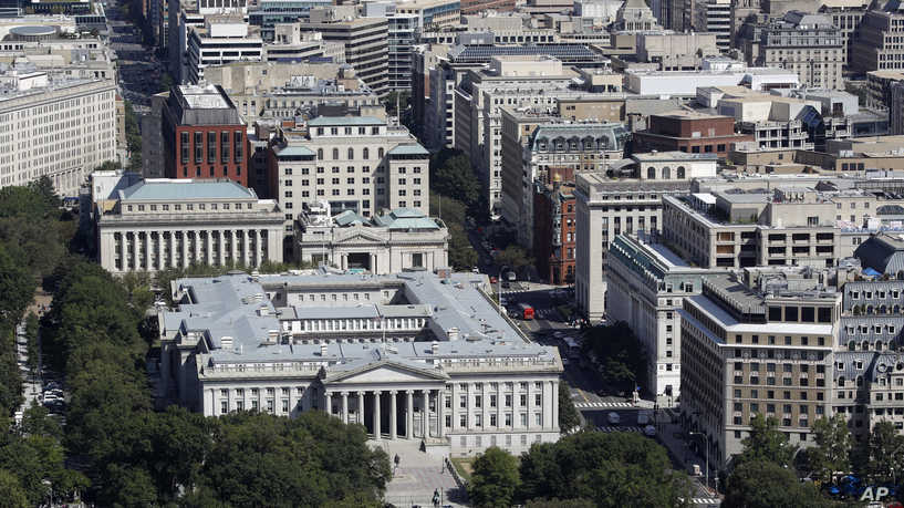 The U.S. Treasury Department building, bottom left, and downtown Washington viewed from the Washington Monument, Wednesday, Sept. 18, 2019, in Washington. (AP Photo/Patrick Semansky)