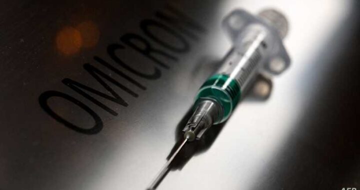 An illustration picture taken on January 19, 2022, shows a syringe next to the word "Omicron". (Photo by Kirill KUDRYAVTSEV / AFP)