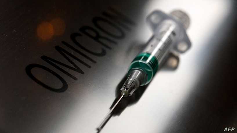 An illustration picture taken on January 19, 2022, shows a syringe next to the word "Omicron". (Photo by Kirill KUDRYAVTSEV / AFP)