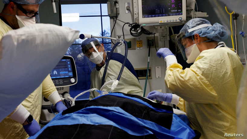 FILE PHOTO: Medical staff treat a coronavirus disease (COVID-19) patient in their isolation room on the Intensive Care Unit (ICU) at Western Reserve Hospital in Cuyahoga Falls, Ohio, U.S., January 4, 2022. REUTERS/Shannon Stapleton/File Photo