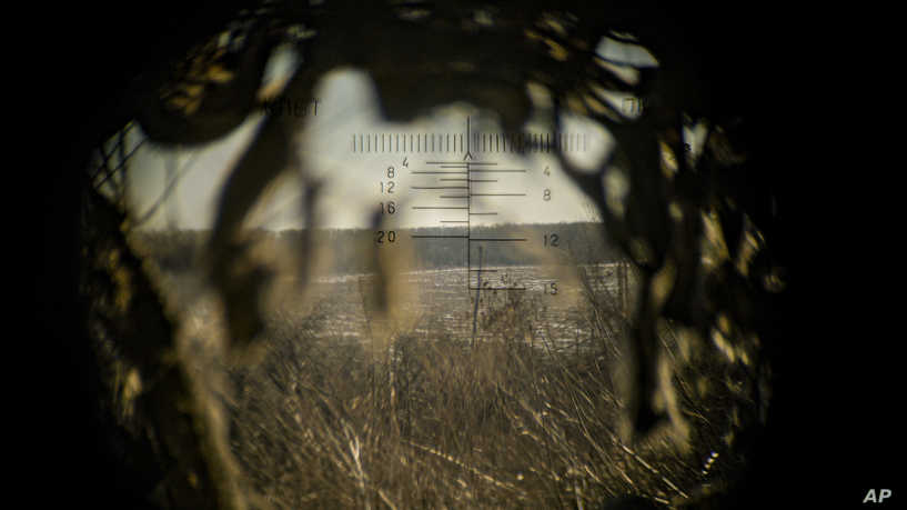 Land is seen through a machine gun spotting optic, outside Popasna, Luhansk region, eastern Ukraine, Monday, Feb. 14, 2022. Russia's Foreign Minister Sergey Lavrov advised President Vladimir Putin on Monday to keep talking with the West on Moscow's security demands, a signal from the Kremlin that it intends to continue diplomatic efforts amid U.S. warnings of an imminent Russian invasion of Ukraine.(AP Photo/Vadim Ghirda)