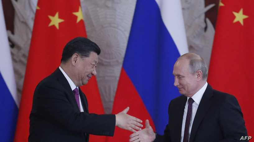 Russian President Vladimir Putin and his Chinese counterpart Xi Jinping shake hands at the end of a joint press conference following their talks at the Kremlin in Moscow on June 5, 2019. (Photo by Maxim SHIPENKOV / POOL / AFP)