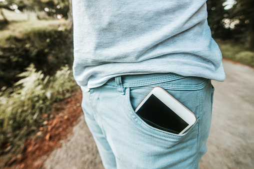 A mobile phone inside a jeans pocket