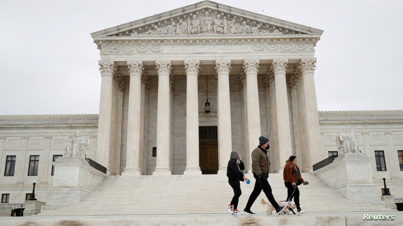 FILE PHOTO: Visitors walk their dogs across the Supreme Court Plaza during a storm on Capitol Hill in Washington, U.S., February 22, 2022. REUTERS/Tom Brenner/File Photo