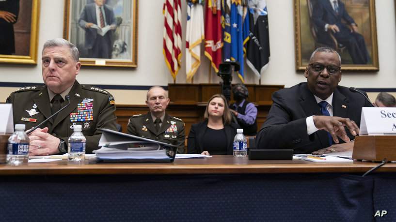 Chairman of the Joint Chiefs of Staff Gen. Mark Milley listens as Secretary of Defense Lloyd Austin speaks during a House Armed Services Committee hearing on the fiscal year 2023 defense budget, Tuesday, April 5, 2022, in Washington. (AP Photo/Evan Vucci)